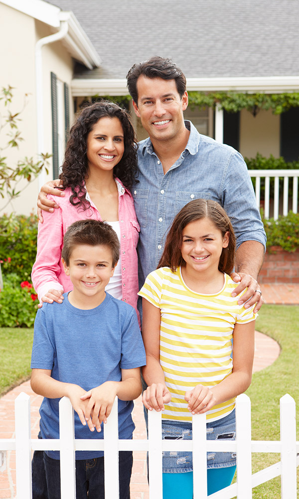 A white picket fence surrounding a picturesque home.