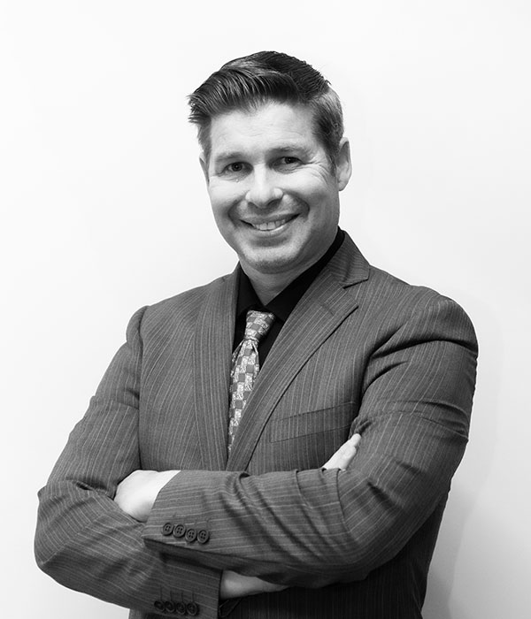 A black and white photo of a man in a suit.