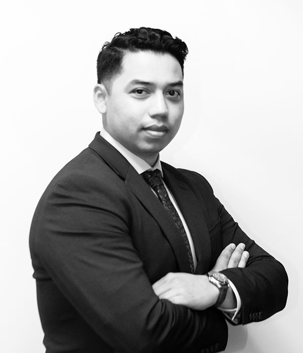 A black and white photo of a man in a suit.