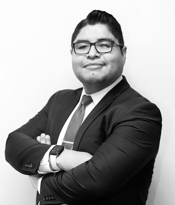 A black and white photo of a man in a suit and tie.